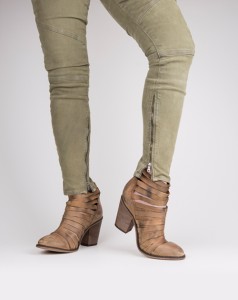 HerringStone’s These hybrid boots are delightfully distressed and feature a stacked heel with full coverage to mid-instep. We adore the strappy accents and chic appeal.