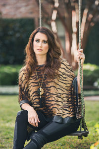 MOODY BLUES BOUTIQUE Take a walk on the wild side with this precious tiger print top with leather detailing. Add a statement necklace with black tassel and leather embellished leggings for a luxe look.